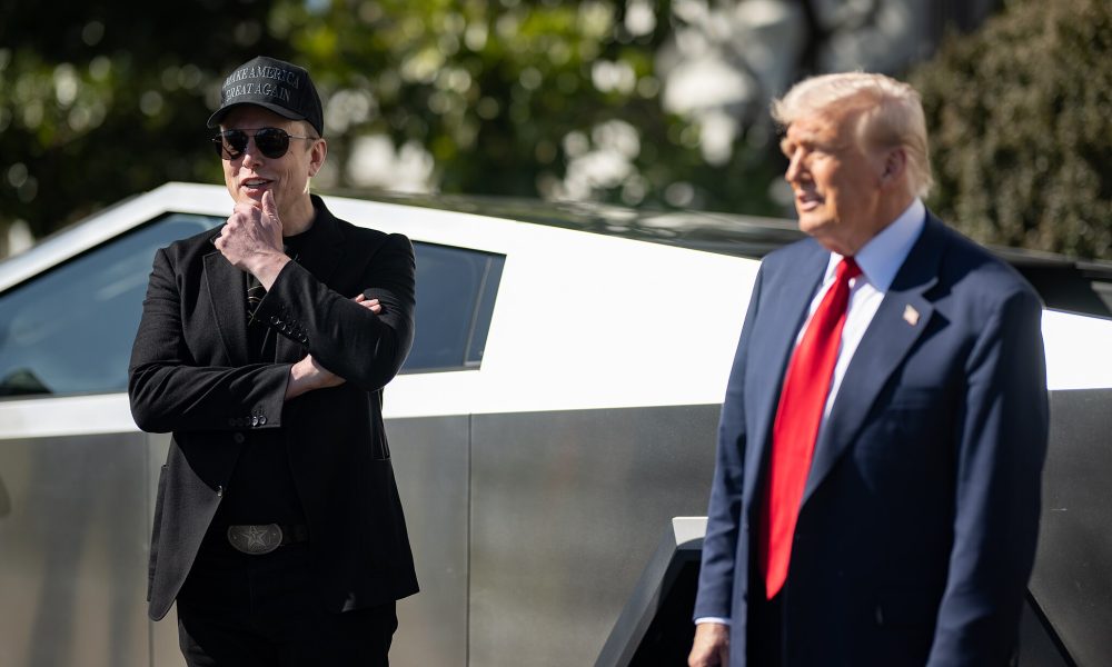 elon musk and donald trump in front of a tesla cybertruck at the white house