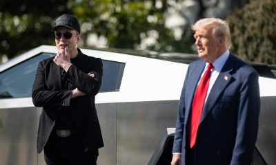 elon musk and donald trump in front of a tesla cybertruck at the white house